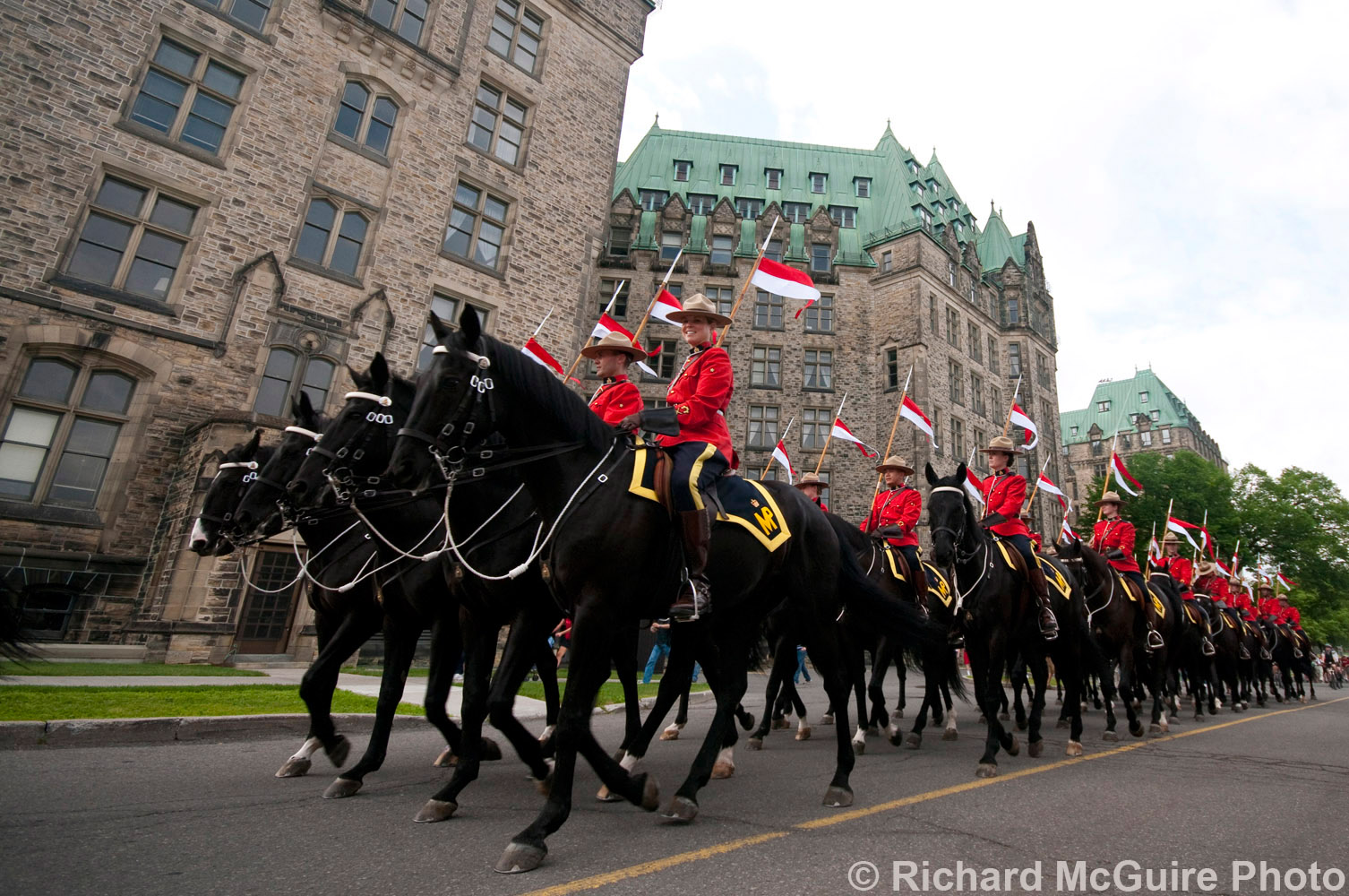 Mounties ride up Parliament Hill to perform the Musical Ride on Canada Day